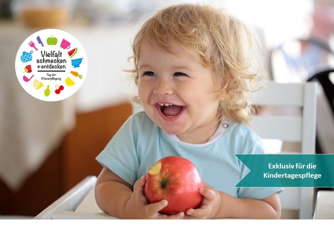 Kind lacht und hat Apfel in der Hand